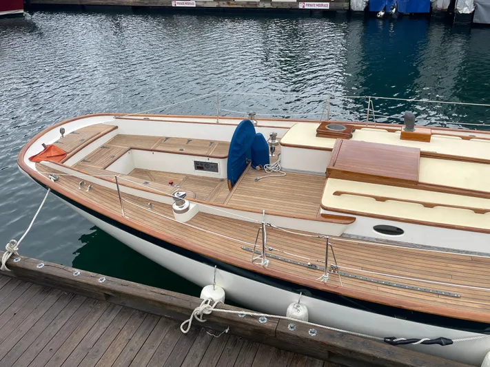 "warm Rain Ii" Yacht Photos Pics Custom Bruce King 1992 sailboat docked, featuring wooden deck and sleek design.