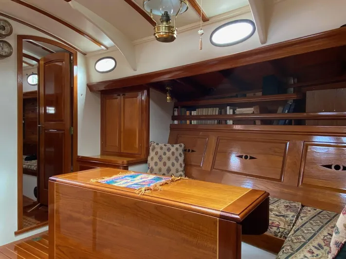 "warm Rain Ii" Yacht Photos Pics Luxurious wooden interior of a 1992 Custom Bruce King yacht, featuring elegant cabinetry and seating.