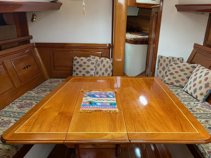 "warm Rain Ii" Yacht Photos Pics Luxurious wooden interior of a 1992 Custom Bruce King yacht with elegant seating and table.
