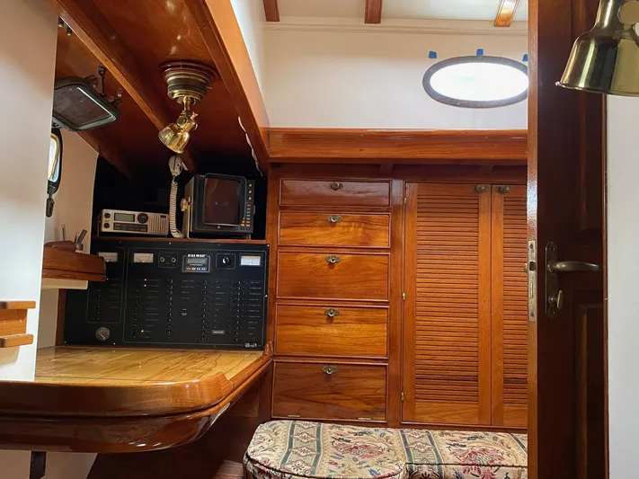 "warm Rain Ii" Yacht Photos Pics Cozy wooden cabin interior with storage, desk, and vintage electronics on a 1992 Bruce King custom boat.