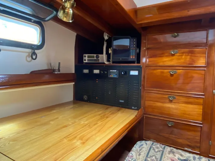 "warm Rain Ii" Yacht Photos Pics Wooden boat interior with navigation equipment, desk, and drawers, Custom Bruce King 1992 model.