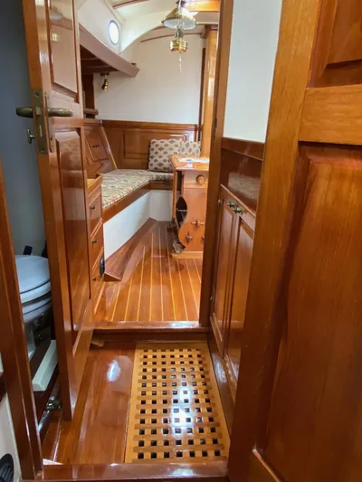 "warm Rain Ii" Yacht Photos Pics Luxurious wooden interior of a 1992 custom Bruce King boat, featuring polished floors and cozy seating.