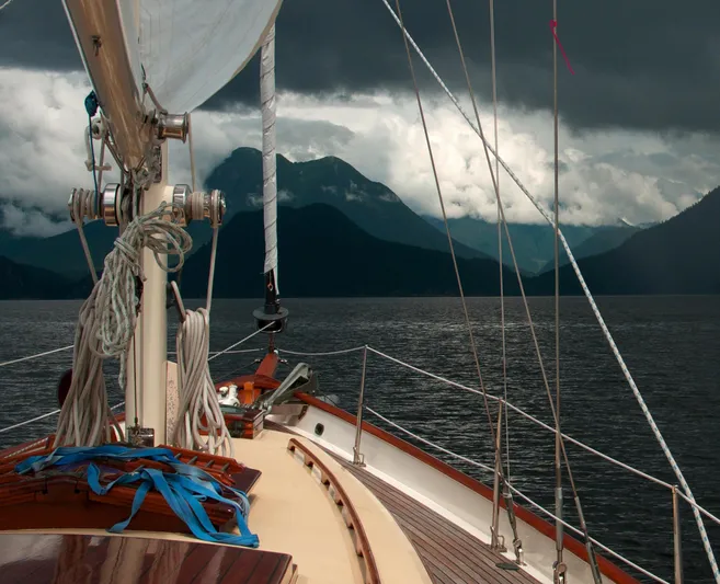 "warm Rain Ii" Yacht Photos Pics Sailing yacht on a stormy sea with mountainous backdrop, Custom Bruce King 1992.