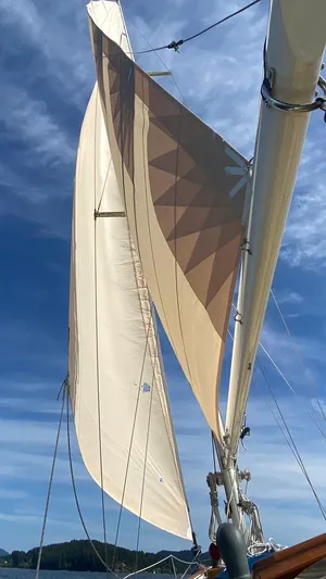 "warm Rain Ii" Yacht Photos Pics Sailboat with custom Bruce King sails, 1992, against a clear blue sky.