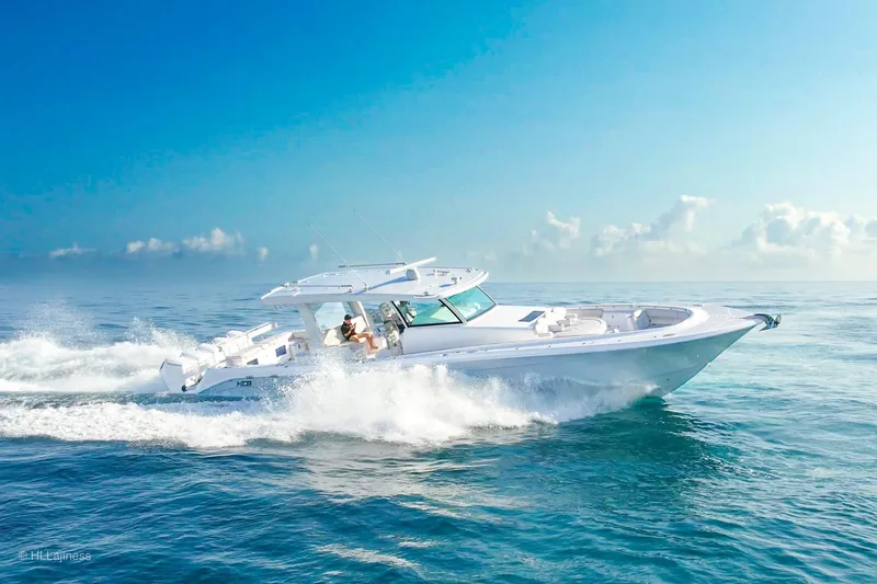  Yacht Photos Pics 2026 HCB 56 Suenos GIX cruising on open ocean under clear blue sky.