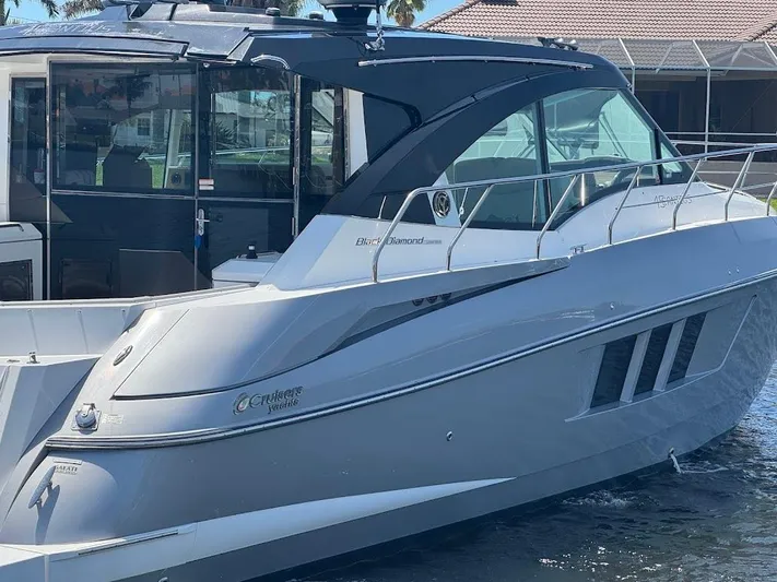 Yacht Photos Pics 2014 Cruisers Yachts 45 Cantius Black Diamond, sleek design, docked in marina.