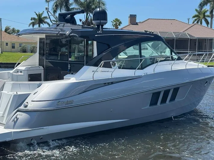 Yacht Photos Pics 2014 Cruisers Yachts 45 Cantius Black Diamond on water, sleek design, sunny day.