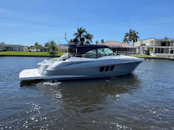  Yacht Photos Pics 2014 Cruisers Yachts 45 Cantius Black Diamond on a sunny waterfront.