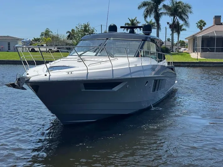  Yacht Photos Pics 2014 Cruisers Yachts 45 Cantius Black Diamond on a sunny waterfront.