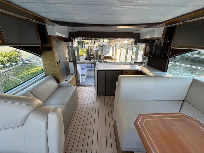  Yacht Photos Pics Interior of 2014 Cruisers Yachts 45 Cantius Black Diamond with elegant seating and wooden flooring.