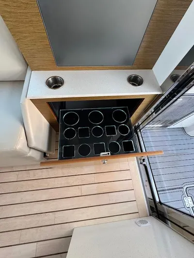  Yacht Photos Pics 2014 Cruisers Yachts 45 Cantius Black Diamond interior with cup holders and storage drawer.