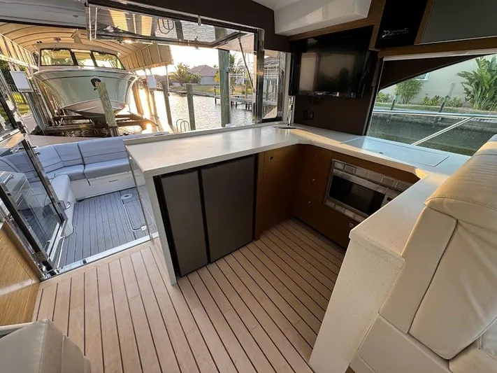  Yacht Photos Pics 2014 Cruisers Yachts 45 Cantius Black Diamond interior with modern kitchen and seating area.