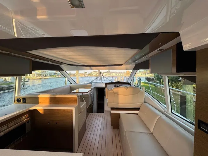  Yacht Photos Pics Luxurious interior of 2014 Cruisers Yachts 45 Cantius Black Diamond with modern seating and helm.