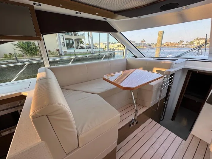  Yacht Photos Pics Interior of 2014 Cruisers Yachts 45 Cantius Black Diamond with elegant seating and table.