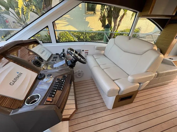  Yacht Photos Pics 2014 Cruisers Yachts 45 Cantius Black Diamond helm with Garmin system and plush seating.