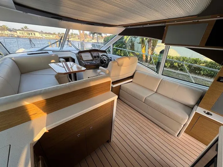  Yacht Photos Pics Luxurious interior of 2014 Cruisers Yachts 45 Cantius Black Diamond with elegant seating and helm.