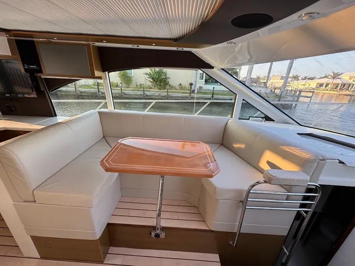  Yacht Photos Pics Luxurious interior of 2014 Cruisers Yachts 45 Cantius Black Diamond with elegant seating and table.