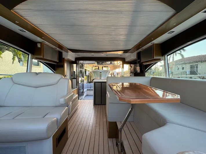  Yacht Photos Pics Luxurious interior of 2014 Cruisers Yachts 45 Cantius Black Diamond with elegant seating and table.