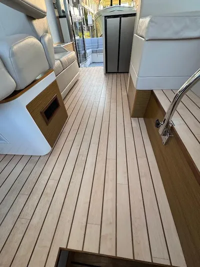  Yacht Photos Pics 2014 Cruisers Yachts 45 Cantius Black Diamond interior with sleek wood flooring and modern seating.