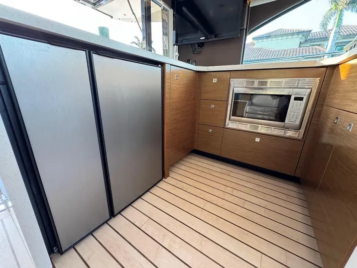  Yacht Photos Pics Modern kitchen area on 2014 Cruisers Yachts 45 Cantius Black Diamond with stainless appliances.