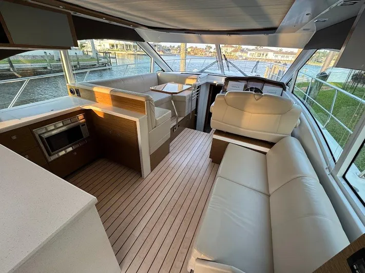 Yacht Photos Pics Luxurious interior of 2014 Cruisers Yachts 45 Cantius Black Diamond with modern seating and kitchen.