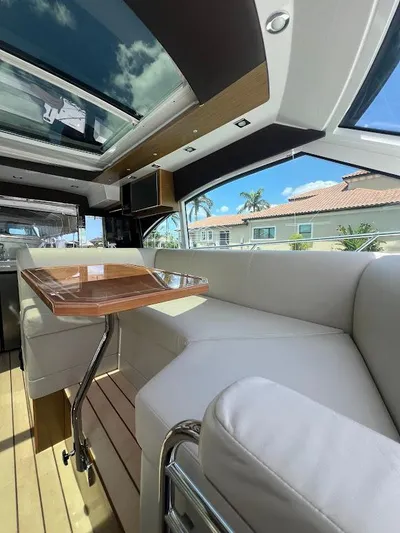  Yacht Photos Pics Luxurious interior of 2014 Cruisers Yachts 45 Cantius Black Diamond with skylight and plush seating.