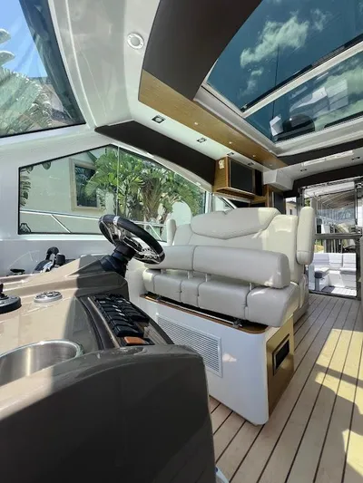  Yacht Photos Pics Luxurious interior of 2014 Cruisers Yachts 45 Cantius Black Diamond with modern helm and seating.