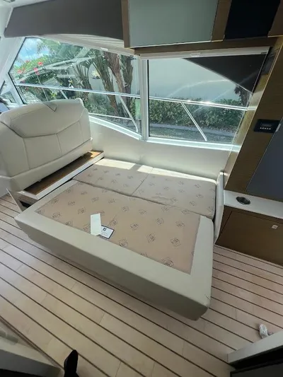  Yacht Photos Pics 2014 Cruisers Yachts 45 Cantius Black Diamond interior with convertible seating and large windows.