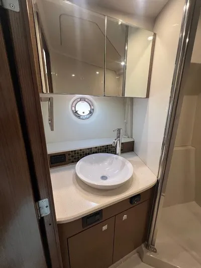  Yacht Photos Pics 2014 Cruisers Yachts 45 Cantius Black Diamond bathroom with modern sink and mirror.