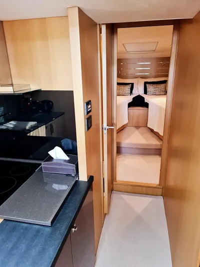  Yacht Photos Pics Interior of 2013 Princess V57 yacht, featuring a modern kitchen and cozy bedroom.
