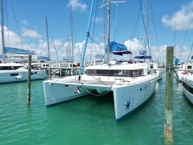 Kajsa Yacht Photos Pics 2017 Lagoon 450 F catamaran docked in a marina with clear blue skies.