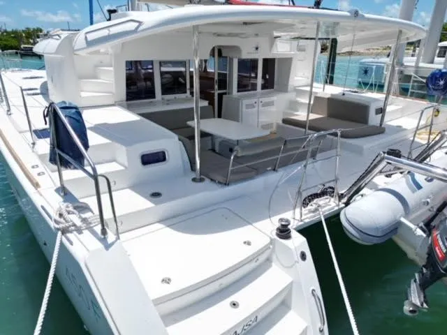 Kajsa Yacht Photos Pics 2017 Lagoon 450 F catamaran with spacious deck and seating area in a marina.