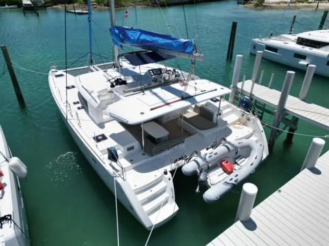 Kajsa Yacht Photos Pics 2017 Lagoon 450 F catamaran docked in a marina, featuring a spacious deck and tender.