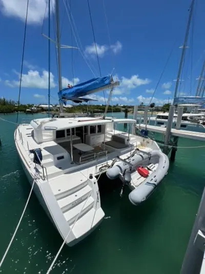 Kajsa Yacht Photos Pics 2017 Lagoon 450 F catamaran docked in a marina with clear blue skies.
