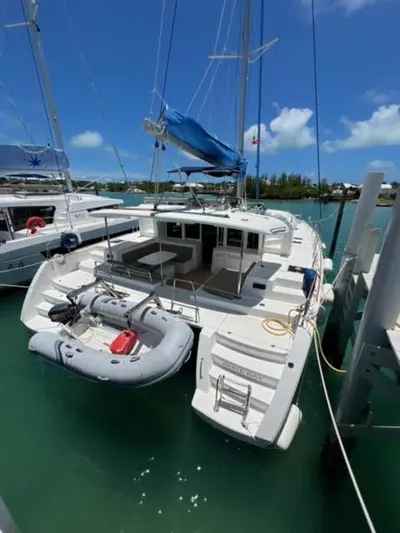 Kajsa Yacht Photos Pics 2017 Lagoon 450 F catamaran docked with inflatable boat, clear skies, and turquoise water.