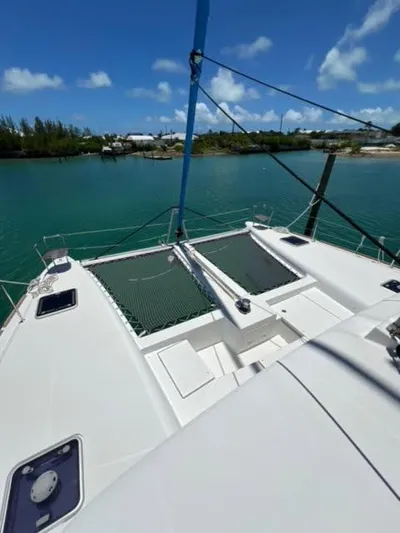 Kajsa Yacht Photos Pics 2017 Lagoon 450 F catamaran on tranquil water under clear blue sky.