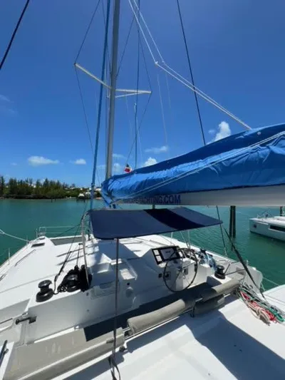 Kajsa Yacht Photos Pics 2017 Lagoon 450 F catamaran with blue sail cover, docked in a serene marina.