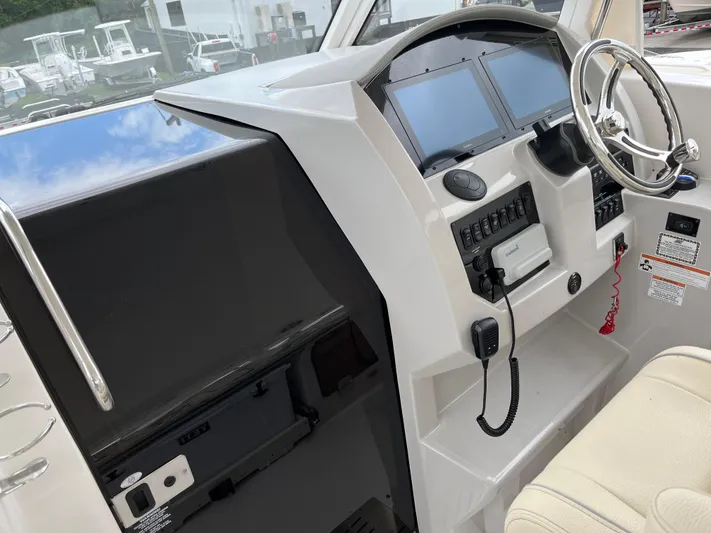 Don't Stop Believin Yacht Photos Pics 2022 Regal 33 SAV boat dashboard with steering wheel and control panels.