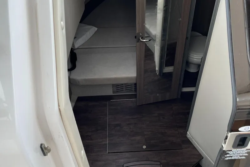 Don't Stop Believin Yacht Photos Pics Interior cabin of 2022 Regal 33 SAV boat with bed and bathroom.
