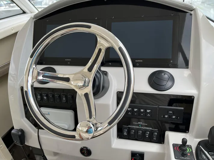 Don't Stop Believin Yacht Photos Pics 2022 Regal 33 SAV helm with dual Garmin displays and modern controls.