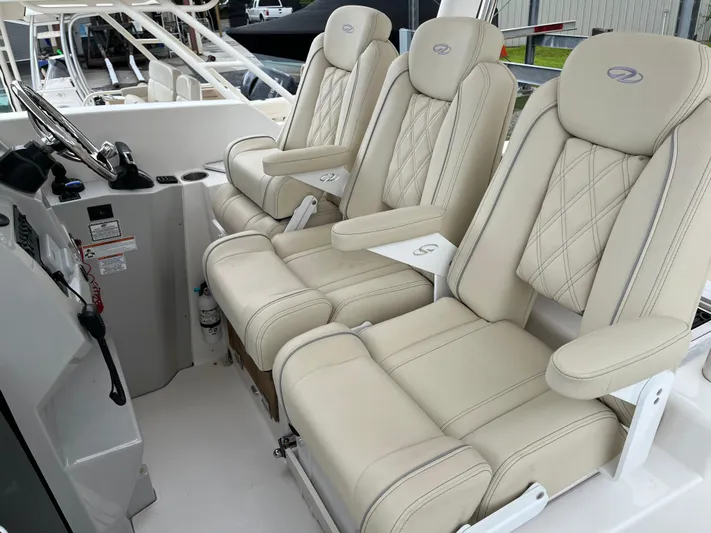 Don't Stop Believin Yacht Photos Pics Luxurious seating on 2022 Regal 33 SAV boat, featuring plush, cream-colored upholstery.