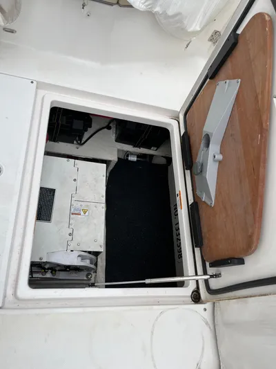 Don't Stop Believin Yacht Photos Pics Open hatch of 2022 Regal 33 SAV boat, revealing interior compartment.