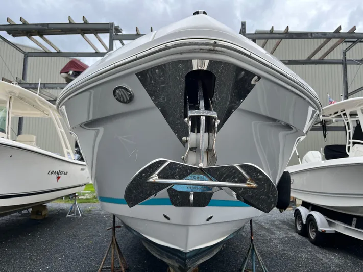 Don't Stop Believin Yacht Photos Pics 2022 Regal 33 SAV boat front view, displayed outdoors with other boats.