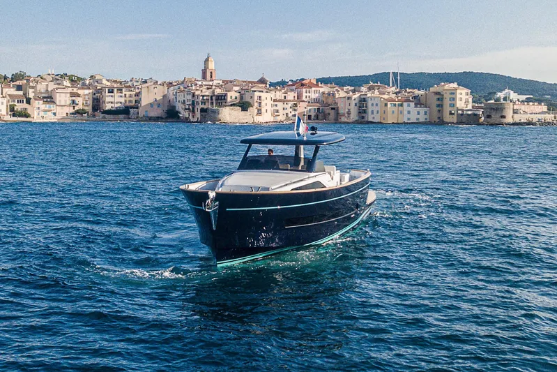  Yacht Photos Pics 2023 Apreamare Gozzo 45 yacht cruising near a coastal town.