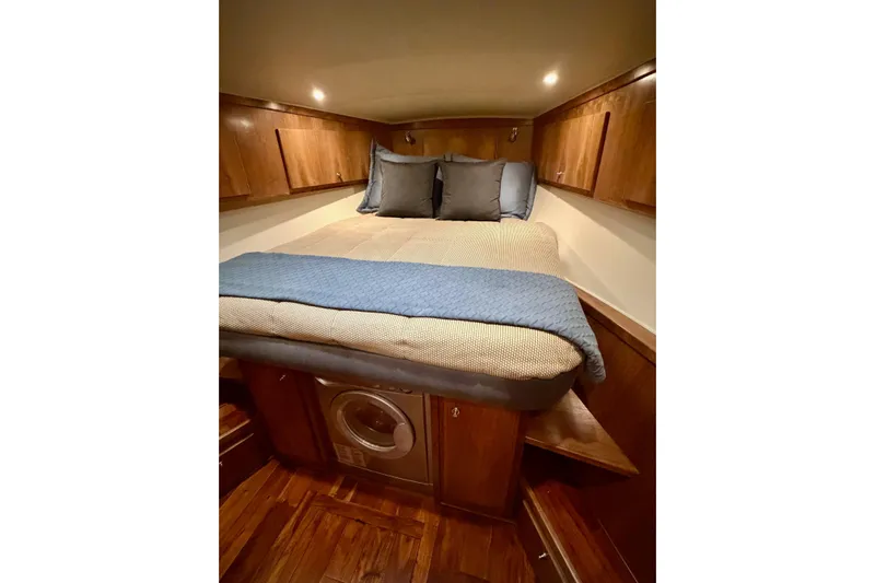  Yacht Photos Pics Cozy bedroom in 2009 Navigator California 50 Veneti yacht with wood cabinets and washer.