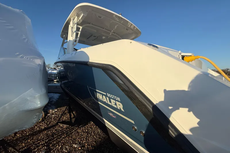  Yacht Photos Pics 2017 Boston Whaler 320 Vantage boat docked, showcasing sleek design and branding.