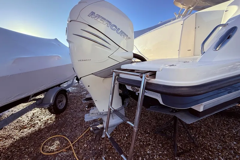  Yacht Photos Pics 2017 Boston Whaler 320 Vantage with Mercury Verado outboard engine, parked on gravel.