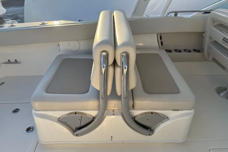  Yacht Photos Pics 2017 Boston Whaler 320 Vantage boat seating with beige cushions and stainless steel accents.