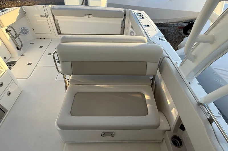  Yacht Photos Pics 2017 Boston Whaler 320 Vantage boat interior with cushioned seating and storage compartments.