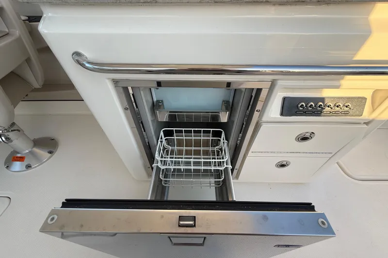  Yacht Photos Pics 2017 Boston Whaler 320 Vantage boat interior with open drawer and control panel.